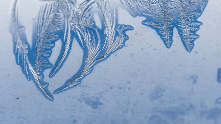 A closeup shot of beautiful frost patterns and textures on glass