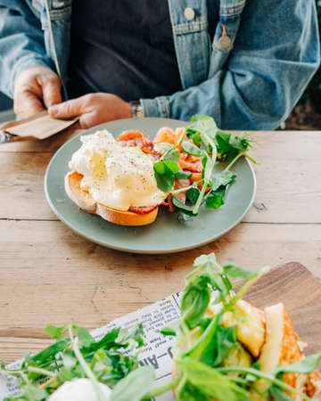An vertical selective closeup shot of breakfast sandwiches in a plateの写真素材