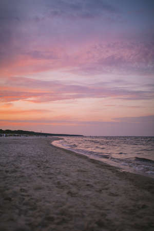 A vertical shot of the beautiful ocean under the colorful sky in the evening
