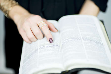 A selective closeup shot of a person reading a bookの写真素材
