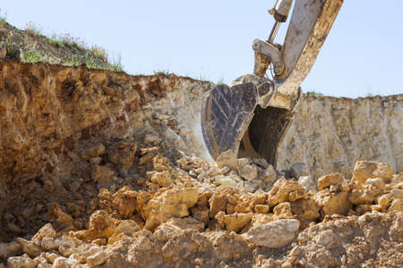 A sunny scenery of an excavator working in a construction area