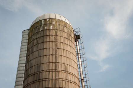 A low angle shot of a tall water tower at a farmの写真素材