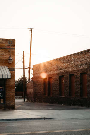 A vertical shot of red brick buildings and stores in a suburban downtown areaの写真素材