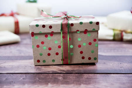 A selective closeup shot of a decorated gift box on a wooden surfaceの写真素材