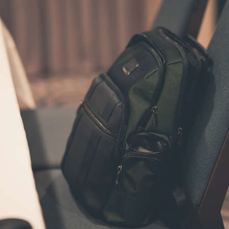 A vertical closeup shot of a dark green backpackの写真素材