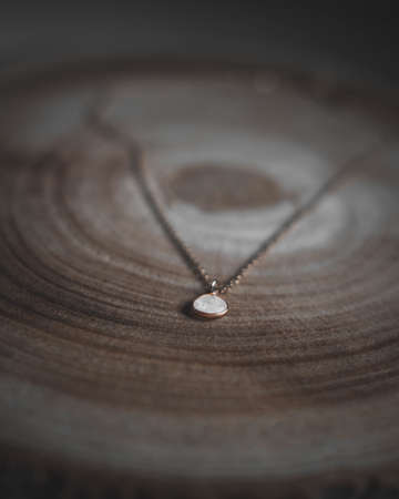 A closeup vertical shot of a necklace with white stoneの写真素材