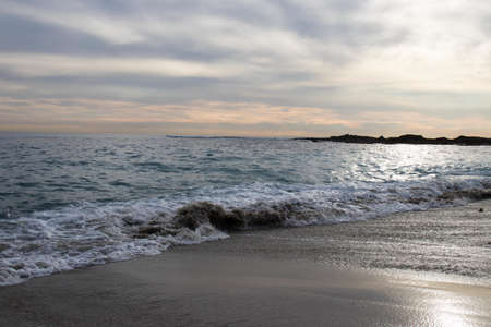 The beautiful scenery of a rocky beach on a sunny and cloudy day
