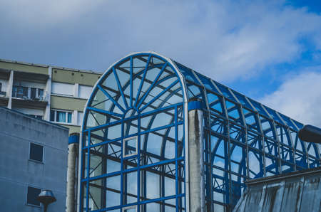 A blue architectural building in the shape of an arch under a blue skyの写真素材