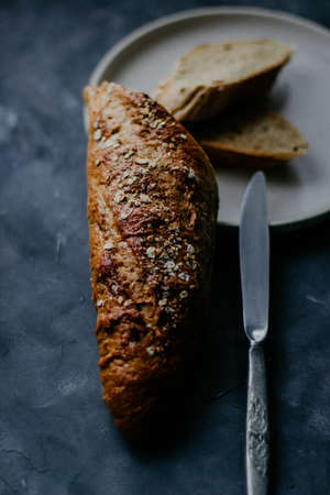 A vertical selective closeup shot of a baked bread on a plate