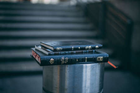 A closeup shot of three small black books stacked on one another