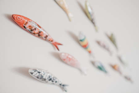 Colorful ceramic fish decors on a white wallの写真素材