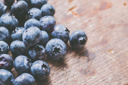 A closeup shot fresh ripe blueberries on a wooden backgroundの写真素材