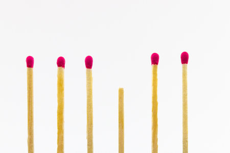 A close up shot of wooden matches separated from each other isolated on a white backgroundの写真素材