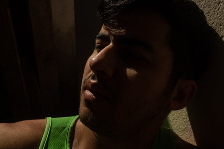 A shallow focus shot of a young Arabian male posing under the sunlight