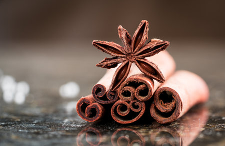 A closeup shot of traditional Christmas spices - star anise with cinnamon and cloves on marble...