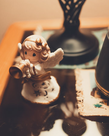 A closeup vertical shot of small angel clay figurineの写真素材