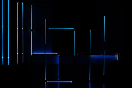 A cool blue neon lights on a black wallの写真素材
