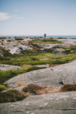 A lot of rock formations on the peninsula near the ocean during daytimeの写真素材