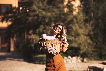 A shallow focus shot of a beautiful female model posing on the street