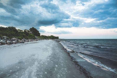 A breathtaking view of the beach and the sea under the beautiful cloudy sky
