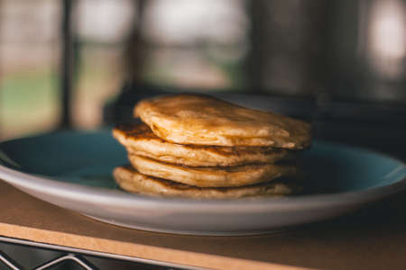 A closeup shot of pancakes with honey on a plate