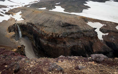 A picture of mineral rocks and a waterfall in Kamchatka, Russia