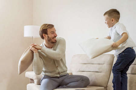 A Caucasian father playing with his chid at home