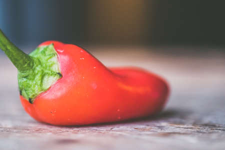 A closeup shot of red hot chili pepper on a wooden surface