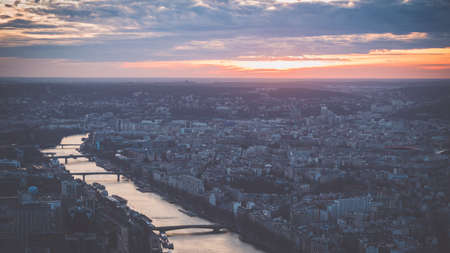 An aerial shot of a city full of high buildings at evening time
