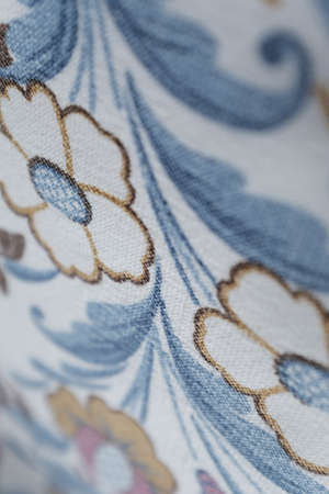 A closeup shot of textured fower patterned wallpaper