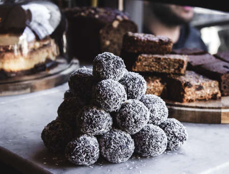 A closeup of dessert balls with coconut powder with a blurred backgroundの写真素材