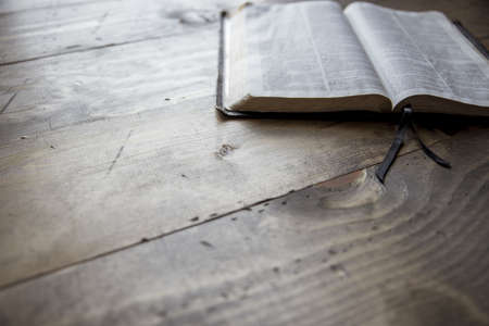 A close shot of an open book on a wooden tableの写真素材