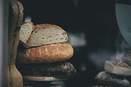 A closeup shot of bread on a wooden tray with a blurred background
