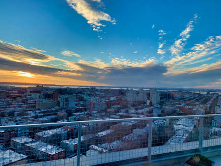 A high angle shot of buildings under a blue cloudy skyの写真素材