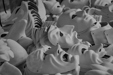 A gray scale shot of some white theater masksの写真素材