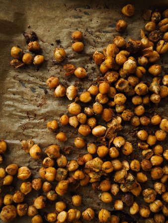 A high angle closeup shot of yellow Baccaurea ramiflora grapes on brown surfaceの写真素材