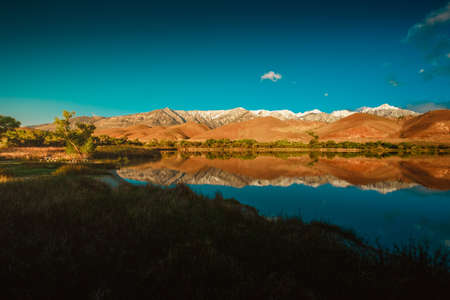 A beautiful reflection of the hills in the clear water of the lake in California
