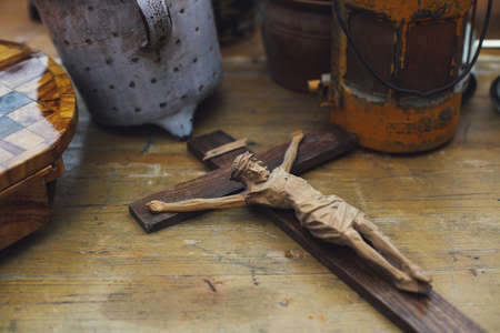 A beautiful shot of the statue of Jesus Christ on the cross on a table in an antique shop