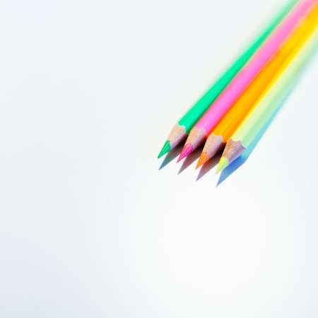 A closeup shot of four colorful pencils on a white background  - back to school conception