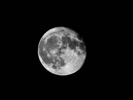 A beautiful closeup greyscale shot of the full moon in the night skyの写真素材