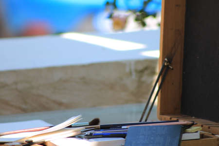 A closeup shot of pens and brushes on a desk with blurred background