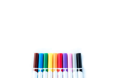 An overhead shot of different color markers on a wite surface - great for backgroundの写真素材