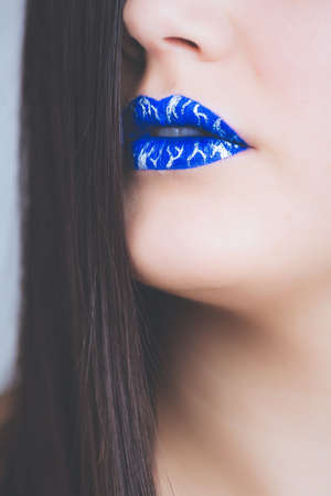 A vertical closeup shot of a female wearing blue lipstick - great for an article about cosmeticsの写真素材