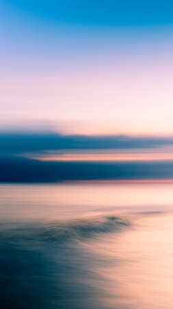 A vertical shot of the purple sky during sunset with thick clouds gathering. Perfect for a wallpaper...