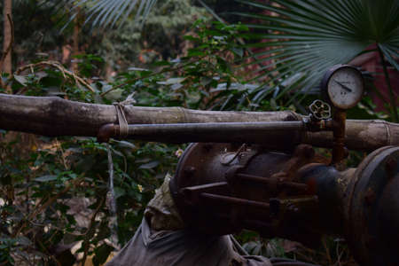 A selective focus shot of an old rusty distillation machineの写真素材