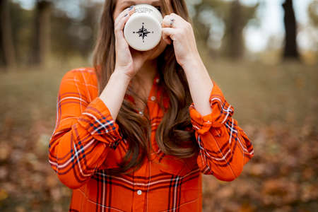 A closeup shot of a female drinking coffee with a blurred background