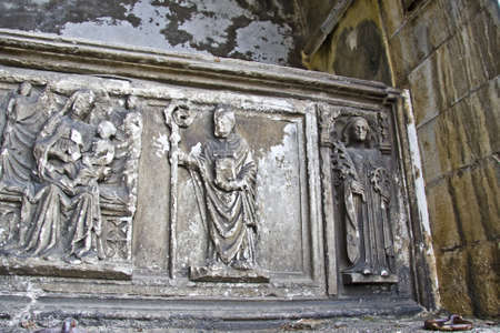 A close shot of a wall with religious sculptings