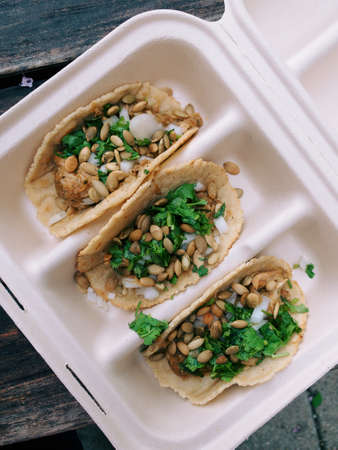 A high angle shot of delicious tacos with vegetables and beans.の写真素材