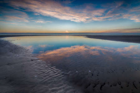 A fascinating shot of the reflection of the beautiful sky in the ocean water