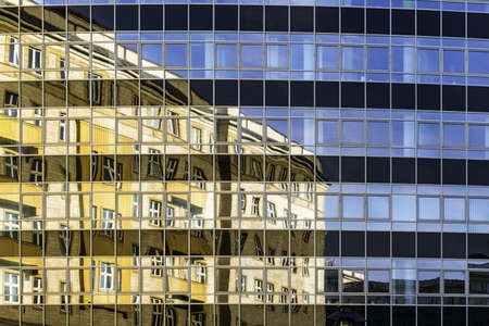 A beautiful shot of a modern building reflecting the life it witnessesの写真素材